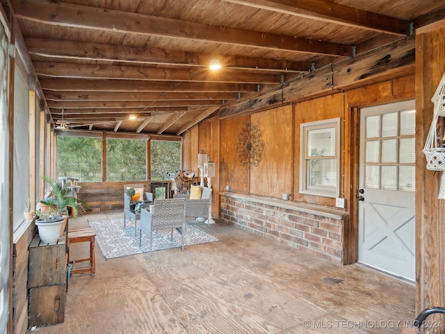 unfurnished sunroom with wooden ceiling and beam ceiling