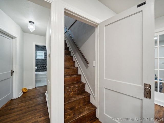 stairs featuring hardwood / wood-style floors