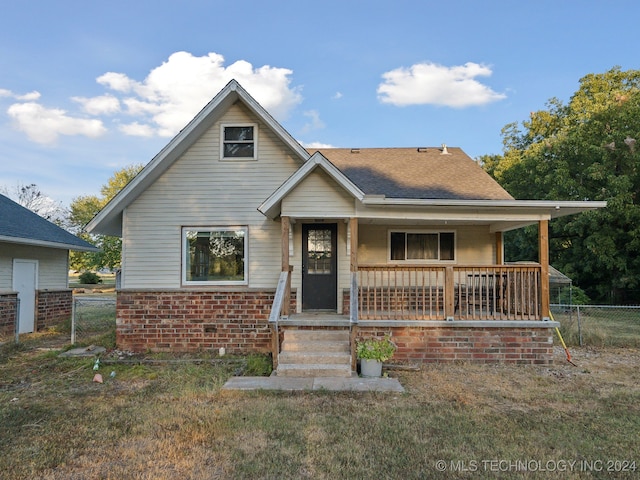 bungalow-style house featuring a porch and a front yard