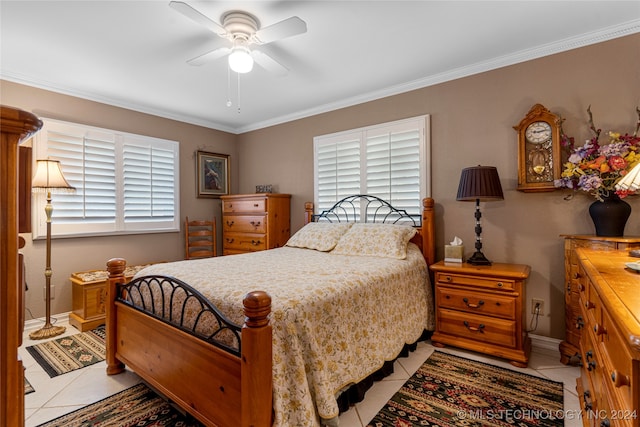 bedroom with multiple windows, light tile patterned floors, ornamental molding, and ceiling fan