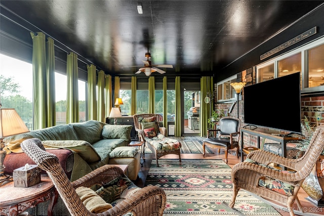 sunroom / solarium featuring ceiling fan and a wealth of natural light