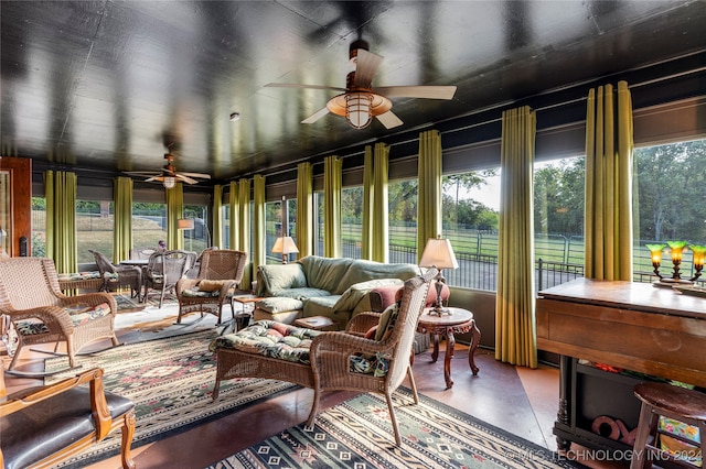 sunroom featuring ceiling fan