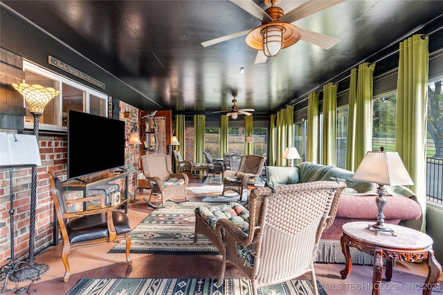 sunroom with ceiling fan and plenty of natural light