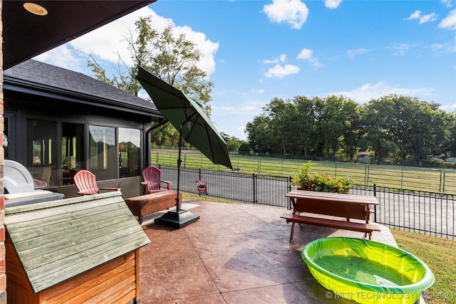 view of patio featuring a sunroom