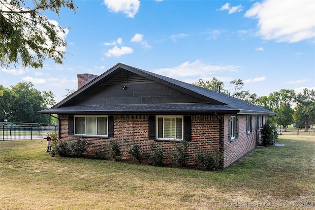 view of side of home with a lawn