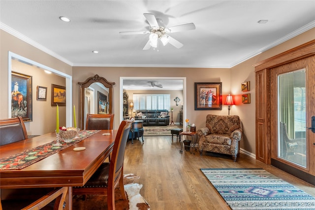 dining space featuring ornamental molding, ceiling fan, and hardwood / wood-style floors