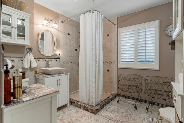 bathroom with walk in shower, vanity, tile walls, and toilet