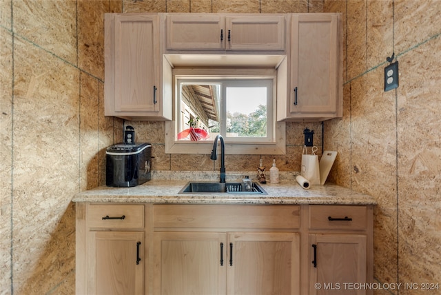 kitchen with light brown cabinetry and sink