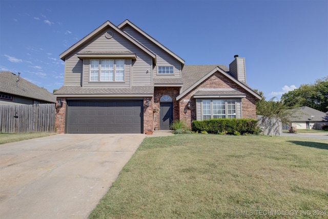 view of front of property featuring a garage and a front yard