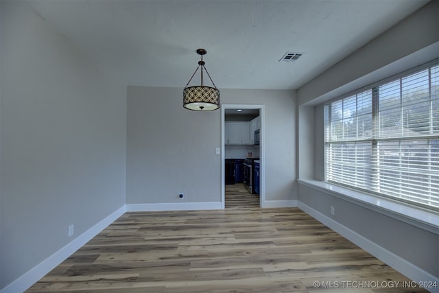 unfurnished dining area with light wood-type flooring