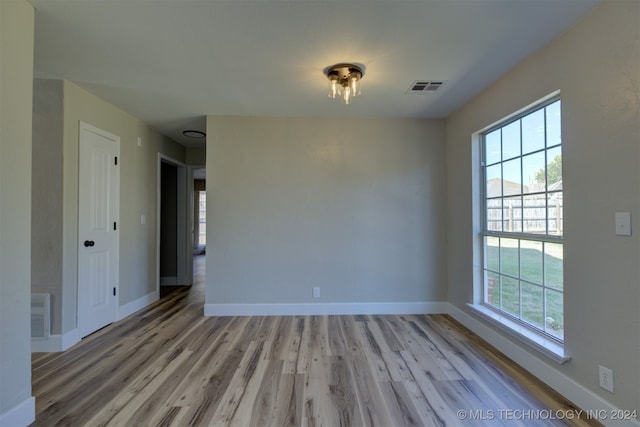 unfurnished room with light hardwood / wood-style flooring and a wealth of natural light