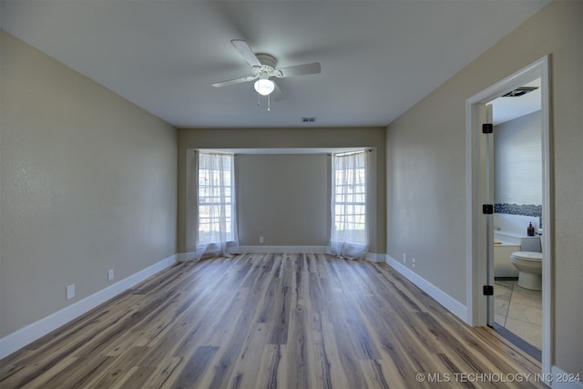 spare room with ceiling fan and hardwood / wood-style flooring