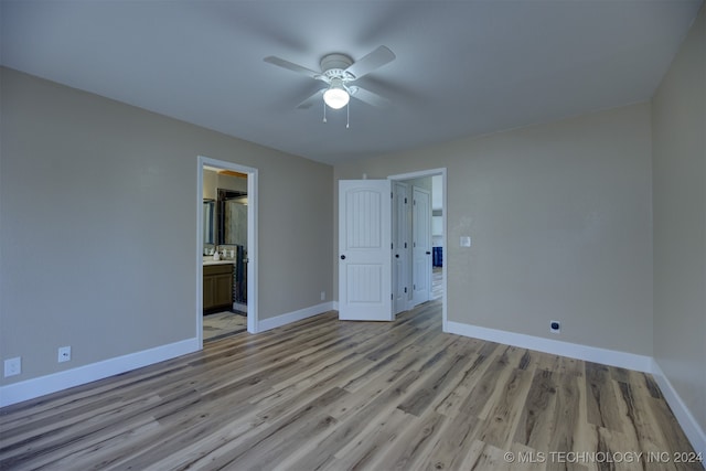 unfurnished bedroom with ceiling fan, light hardwood / wood-style flooring, and ensuite bath