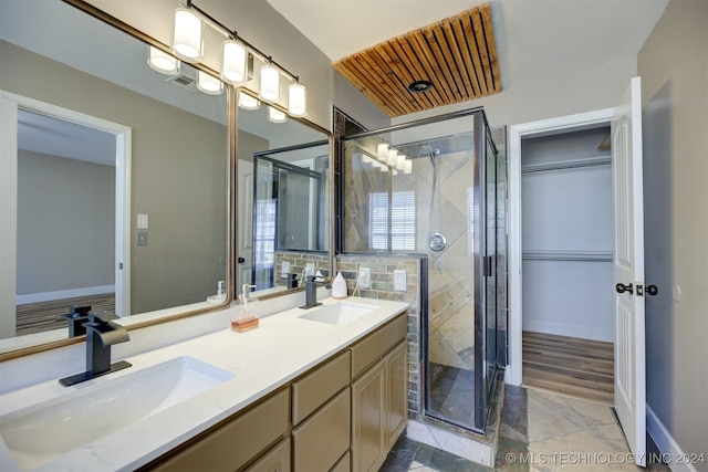 bathroom featuring hardwood / wood-style floors, a shower with door, and vanity