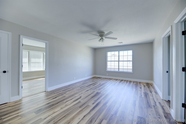 spare room featuring light hardwood / wood-style floors and ceiling fan