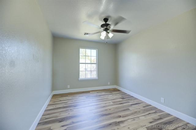 spare room featuring ceiling fan and light hardwood / wood-style floors