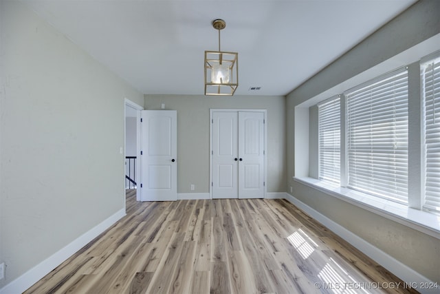 interior space with an inviting chandelier and light wood-type flooring