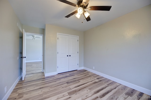 unfurnished bedroom featuring ceiling fan and light hardwood / wood-style floors