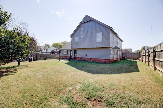 back of house featuring a lawn