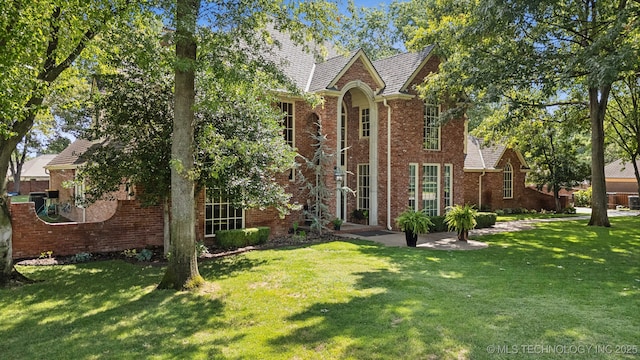 english style home with a front yard