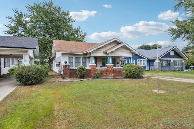 view of front facade with a front lawn and a porch