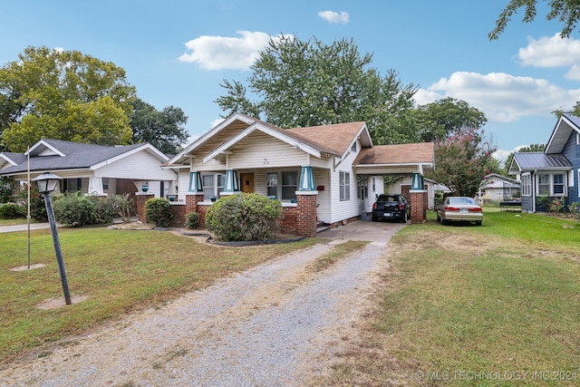 view of front facade with a front lawn and a carport