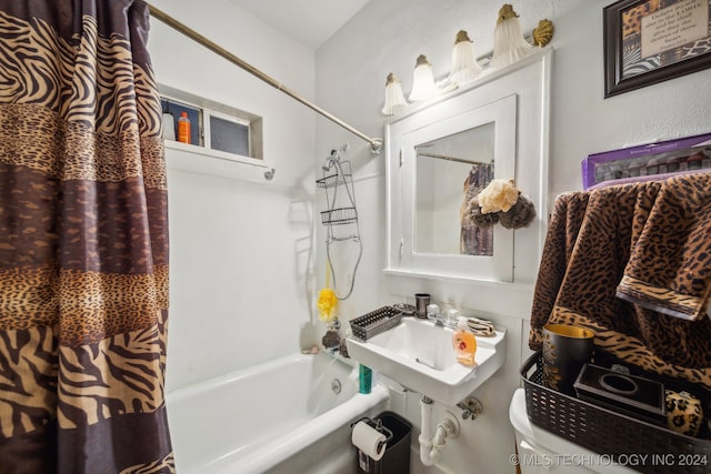 full bathroom with shower / tub combo with curtain, toilet, and sink