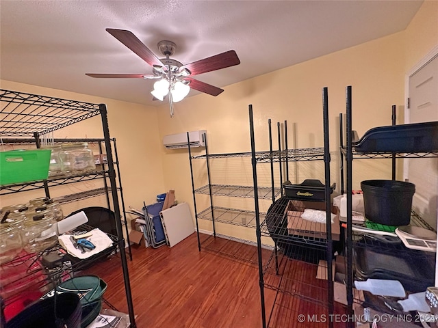 bedroom with hardwood / wood-style floors and a wall mounted air conditioner