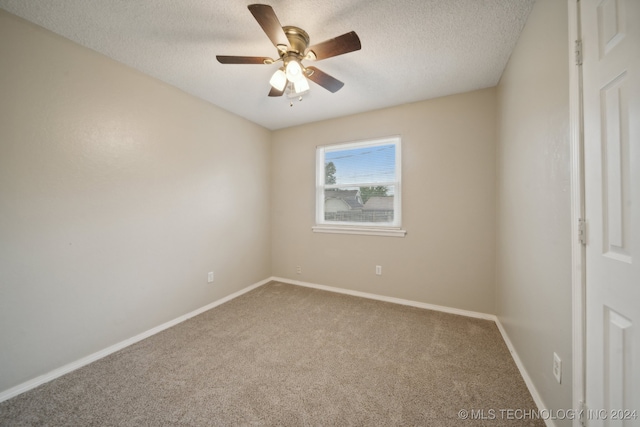 carpeted empty room with a textured ceiling and ceiling fan