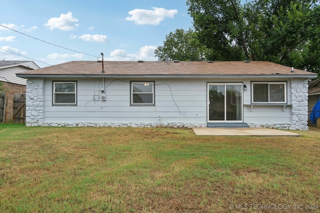 rear view of house featuring a patio and a yard