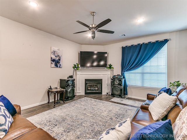 living room with wood-type flooring and ceiling fan