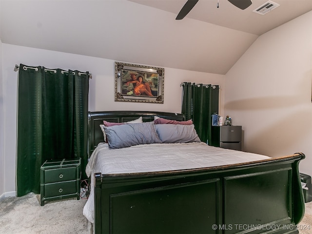 bedroom featuring vaulted ceiling, ceiling fan, and light carpet