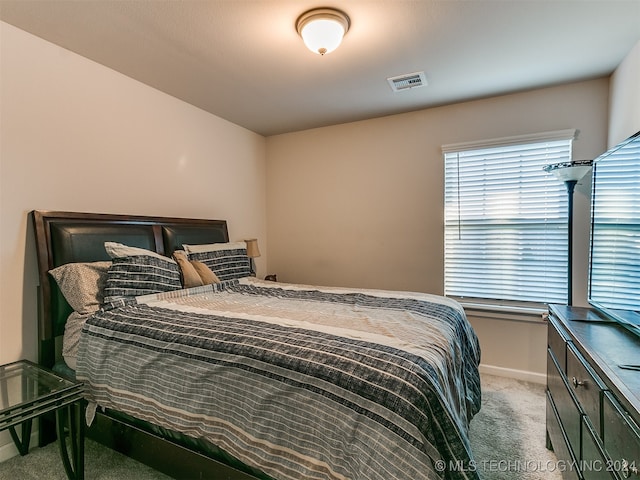 bedroom featuring light carpet