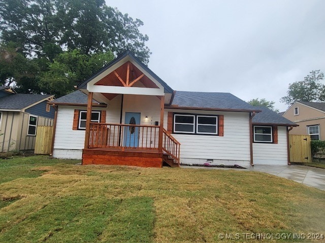 bungalow-style home with a front lawn