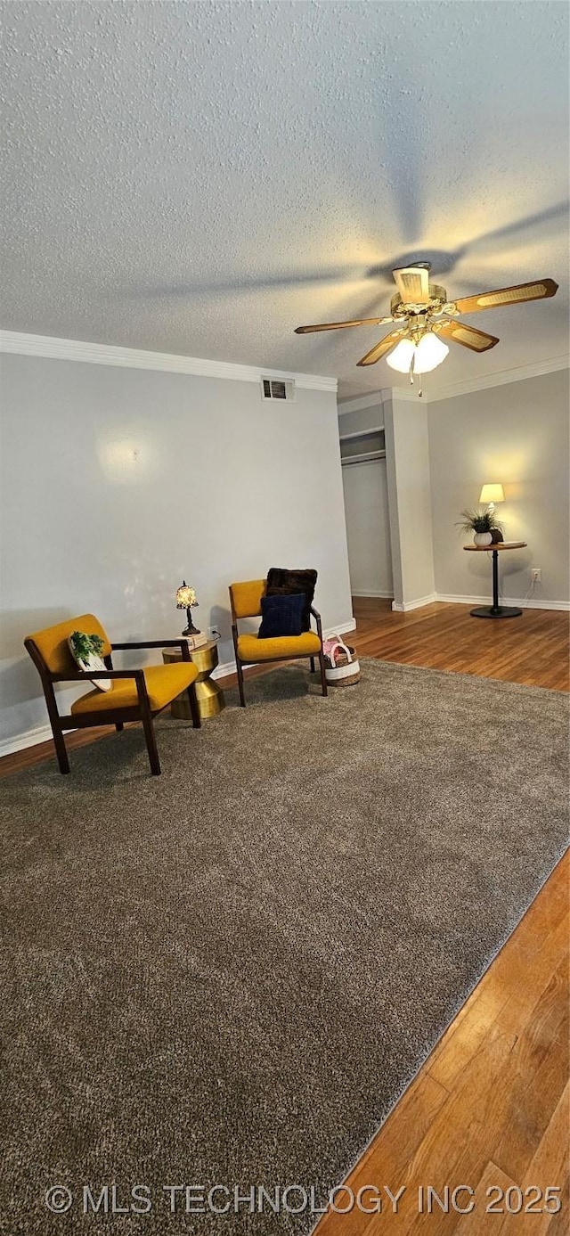 unfurnished room with a textured ceiling, ceiling fan, and hardwood / wood-style flooring