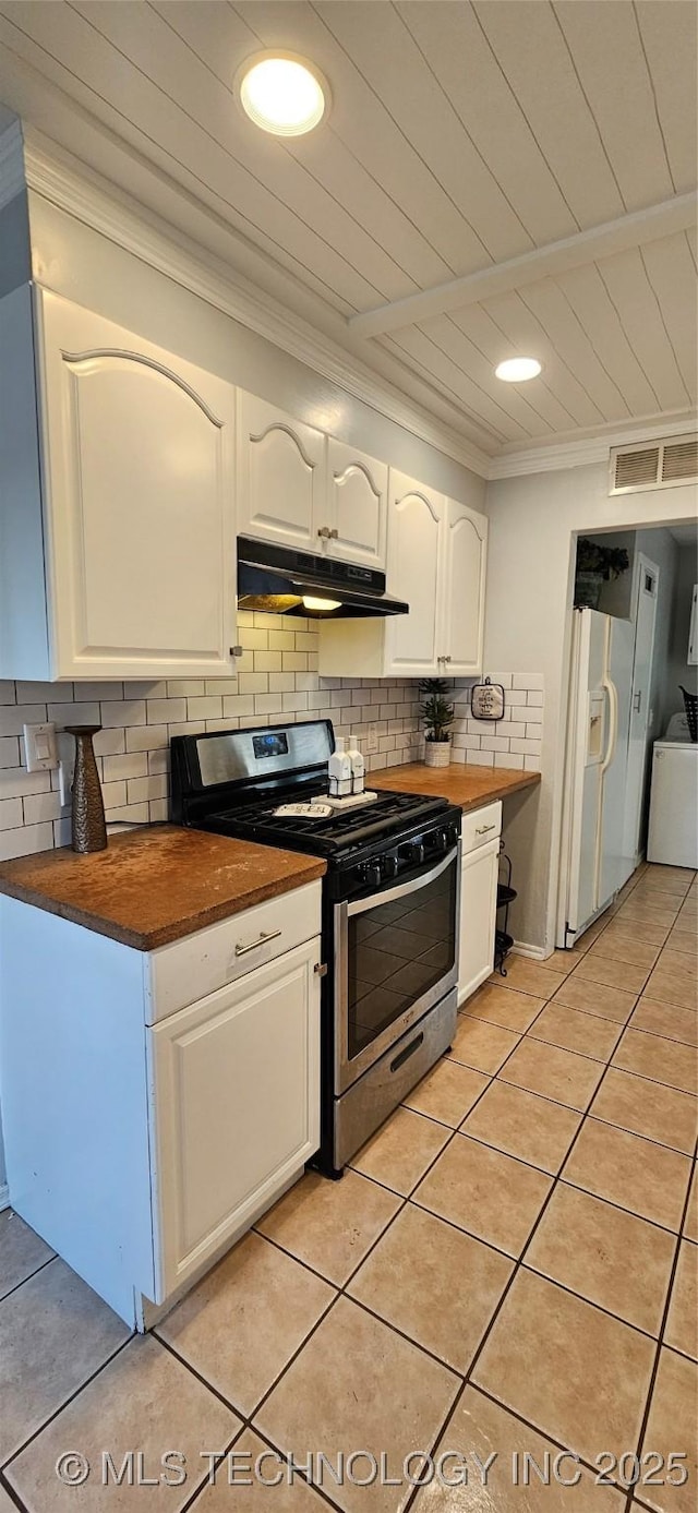 kitchen with white cabinets, white refrigerator with ice dispenser, butcher block counters, stainless steel stove, and light tile patterned flooring