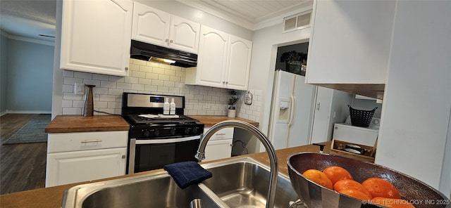 kitchen with white cabinets, butcher block counters, gas stove, and white refrigerator with ice dispenser