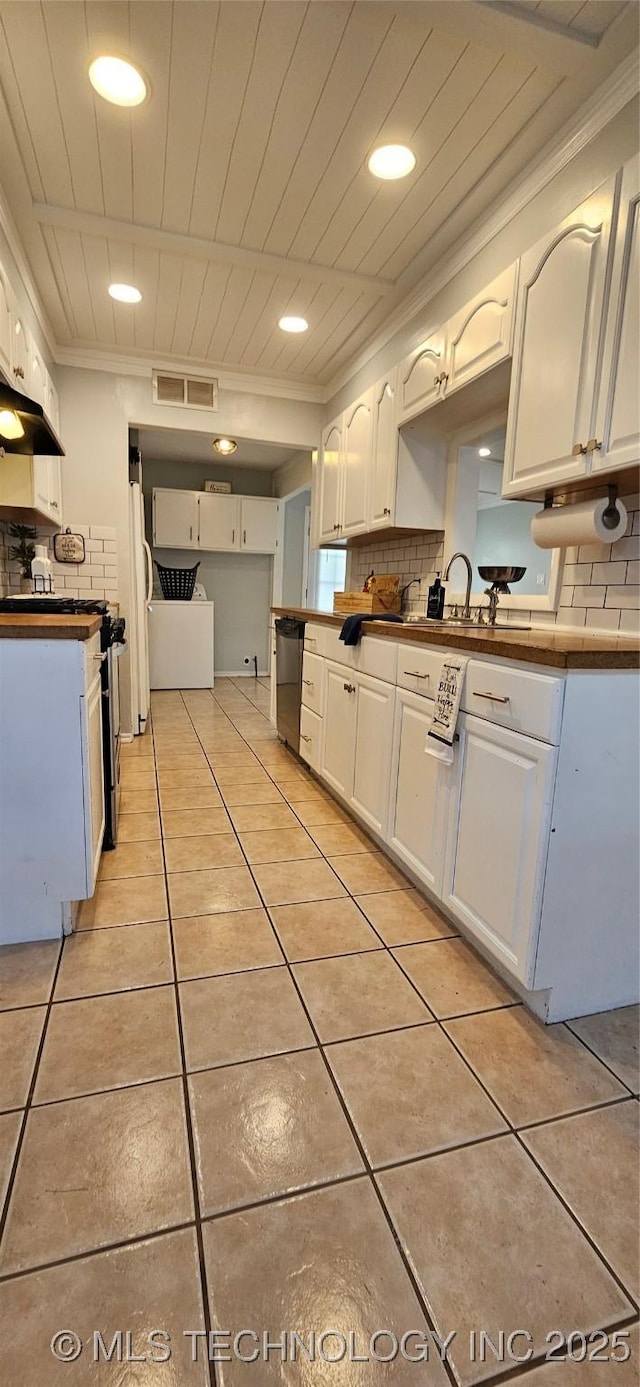 kitchen with white fridge, decorative backsplash, dishwasher, crown molding, and white cabinets