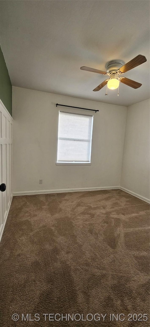 carpeted spare room with ceiling fan