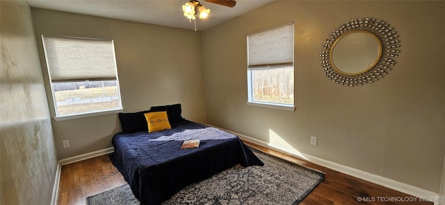 bedroom featuring dark wood-type flooring and ceiling fan