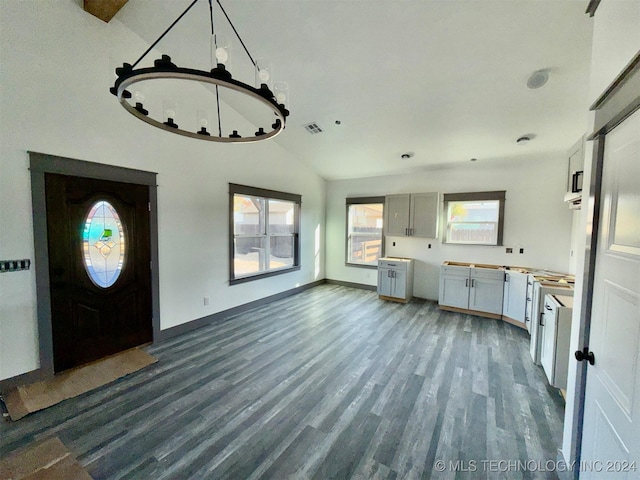 foyer entrance featuring dark hardwood / wood-style floors, lofted ceiling, and a wealth of natural light