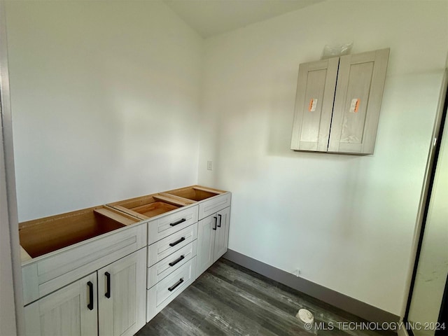 bathroom featuring electric panel and hardwood / wood-style flooring