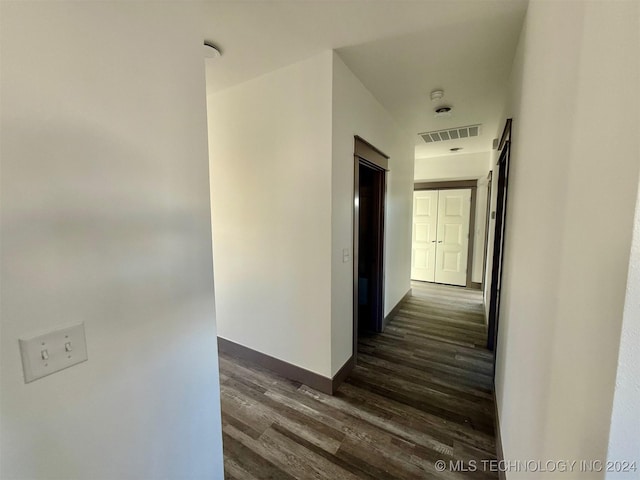 hallway with dark hardwood / wood-style floors