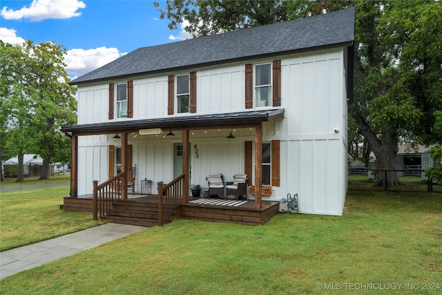 view of front facade with a front yard, outdoor lounge area, and covered porch