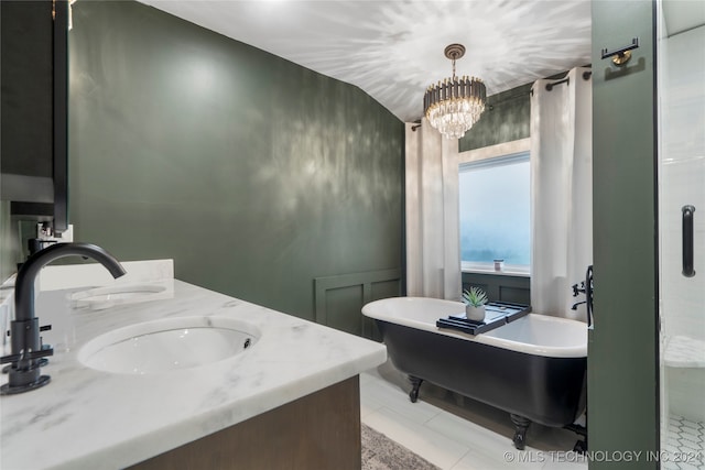 bathroom with a bath, tile patterned flooring, vanity, and a chandelier