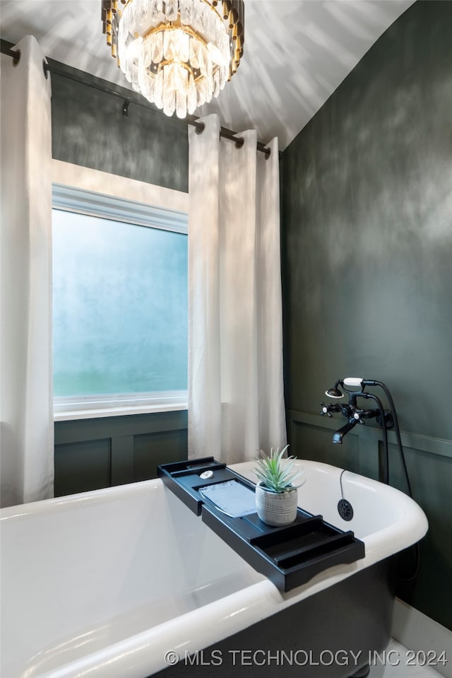 bathroom with lofted ceiling and a tub