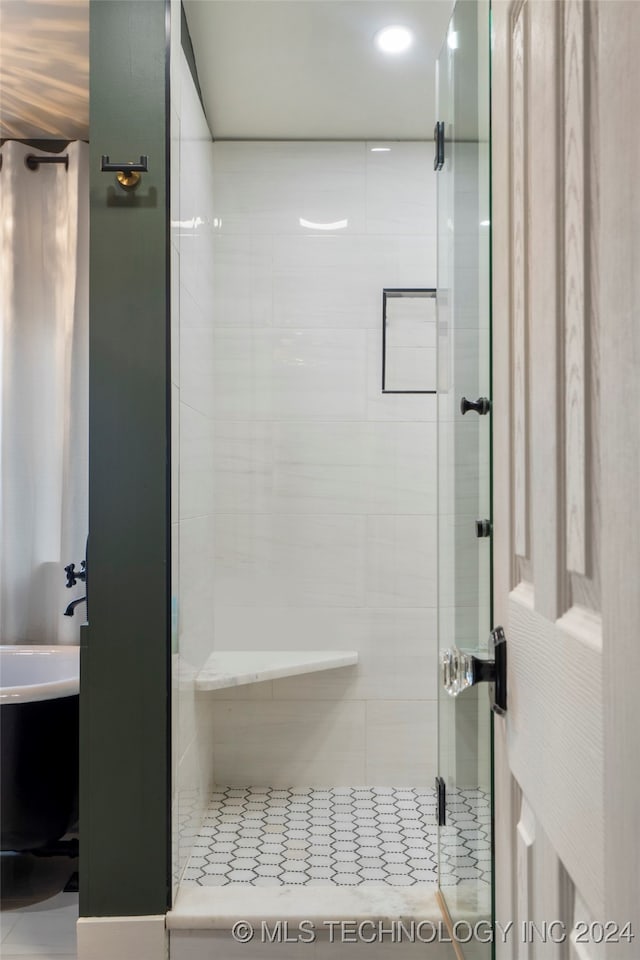 bathroom with tile patterned flooring and a shower with door