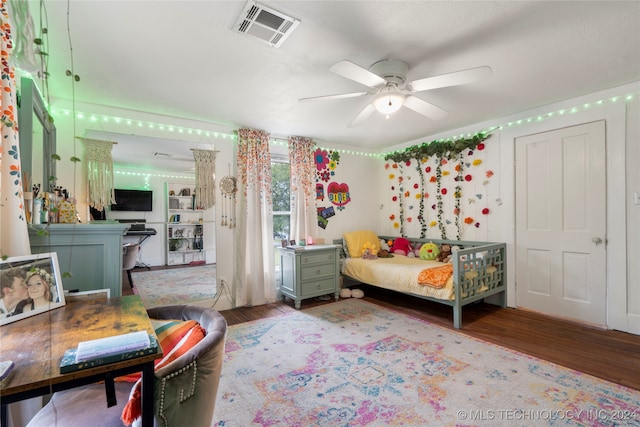 bedroom with ceiling fan and hardwood / wood-style floors