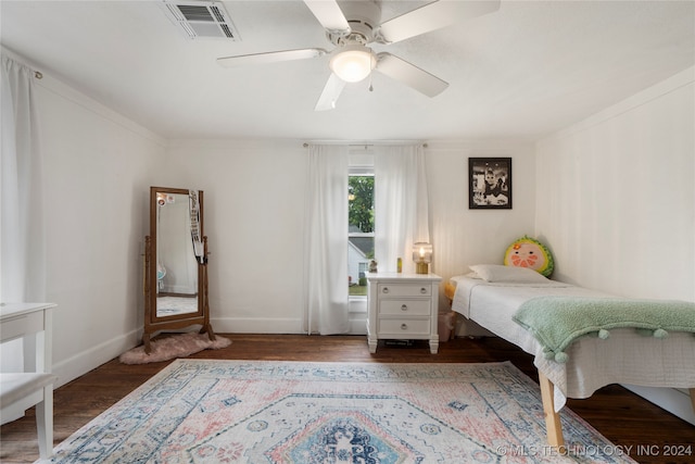 bedroom featuring ornamental molding, hardwood / wood-style floors, and ceiling fan