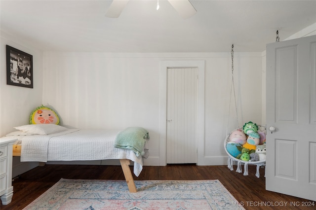 bedroom with dark hardwood / wood-style flooring and ceiling fan